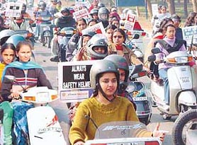 The UT traffic police sends out contradictory signals, as it accommodates girls without helmets in a scooter rally especially designed to stress on road safety in Chandigarh on Saturday .