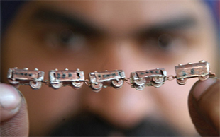 Miniature artist Gurmeet Singh shows his version of Samjhauta Express, a 2.5 inch copper train with five bogies