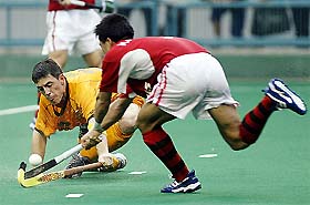 Australia's Ben Bishop stops South Korea's Kim Yong Bae 