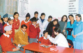 A doctor examines teeth of a kid at a camp organised to mark International Inner Wheel Day at Ludhiana 