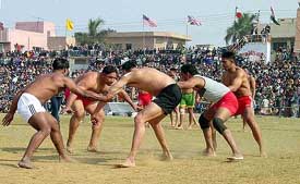 Players of Tony Club of the US and Doaba Club Nakodar struggle for a point during their kabaddi match of second Khalsa Heritage Kabaddi Cup 