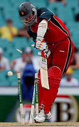 Zimbabwe's Mark Vermeulen is bowled by Australia's Brad Williams 