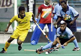 Harpal Singh of India clears the ball from Mohamad Mazli of Malaysia