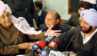 Punjab Chief Minister Amarinder Singh and Higher Education Minister Harnam Das Johar share a light moment at a Press conference