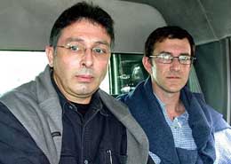 French journalists Jean-Paul Guilloteau and Marc Epstein leave a court in Karachi on Monday after their release