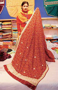 A saleswoman shows the �Vivaha� line of clothing launched by Amartex.