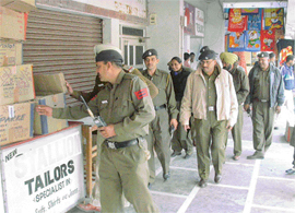The police conducts a search in the Sector 20 market on Tuesday to ward off any threat from Kashmiri militants during the Republic Day celebrations in Chandigarh.