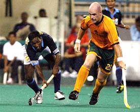 Australia�s Aaron Hopkins battles for the ball with India�s Vikram Pillay during their match at the Sultan Azlan Shah Cup 