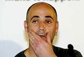 US tennis star Andre Agassi wipes his face during a media conference in Melbourne 