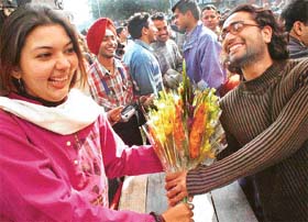 SA student presents a bouquet to his friend to mark Flower Day at Panjab University in Chandigarh