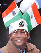 A boy with Tricolours during a pledge ceremony for the elimination of child labour in New Delhi