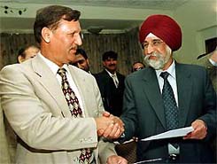 Pakistan Tourism Development Corporation MD Malik Habib shakes hand with Delhi Transport Corporation MD A.J.S. Sahney