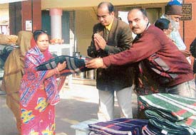 Officials of Bharat Overseas Bank Ltd, Ludhiana branch, distribute blankets at a Lepers Colony in Ludhiana