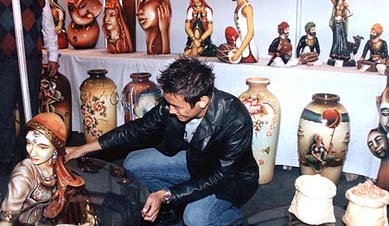 Soccer Star Baichung Bhutia looks at a sculpture after inaugurating a craft fair in Kolkata 