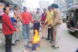 People enjoy the warmth of bonfire