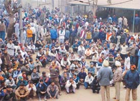 Employees of Avon Cycles sit in dharna in front of its factory in Ludhiana