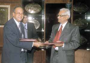 LIC Chairman S. B. Mathur and C&MD of NTPC, C. P. Jain, exchanging documents