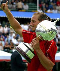David Nalbandian of Argentina holds the trophy after defeating Andre Agassi of the US in the final of the Kooyong International tennis tournament