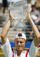 Lleyton Hewitt of Australia raises the Sydney International trophy 