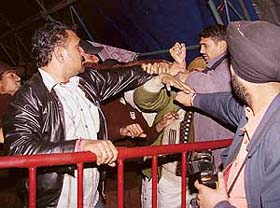 An organiser assaults members of the audience during the "Chal Bhangra Paaiye" show on Sunday in Panchkula