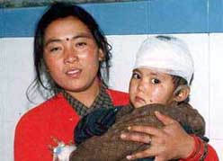 Meena Gurang holds her three-year-old daughter Babita at a Dehradun hospital on Saturday