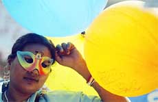 A sex worker holds balloons during a rally by sex workers and transsexuals at the World Social Forum in Mumbai 