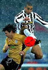 Juventus's French striker David Trezeguet challenges Siena's Vincenzo Riccio during their Serie A soccer match in Turin 