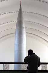 A visitor stands near a Chinese-made rocket at Military Museum in Beijing