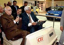 Deputy Prime Minister L.K. Advani, Martui Udyog MD Jagdish Khattar, and former CII President Subhodh Bhargawa take a look at cars on display at the seventh Auto Expo 