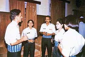 Women officers interact with their men colleagues in the officers mess