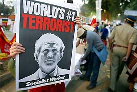 An anti-war activist holds a banner denouncing US President George Bush at the World Social Forum in Mumbai 