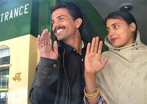 Vasimuddin, a resident of Karachi, along with his Delhi-born bride Ruby wave at the Attari railway station before leaving for Pakistan