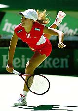 Women's top seed Justine Henin-Hardenne of Belgium serves to Australia's Olivia Lukaszewicz
