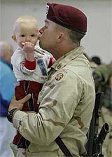 US soldier Cory Kurz kisses his year-old son Jospeh after arriving at Pope Air Force in North Carolina