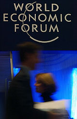 Workers carry papers in the congress centre of the World Economic Forum