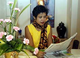 Exiled Bangladeshi author Taslima Nasreen reads a newspaper in a hotel in Kolkata 