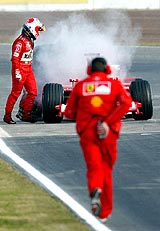 Formula One driver Brazilian Rubens Barrichello gets out of his car after a fire in his Ferrari�s engine at Montmelo racetrack
