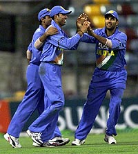 V.V.S. Laxman is congratulated by Yuvraj Singh for catching Zimbabwe's Grant Flower