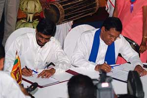 General secretary of the opposition Sri Lanka Freedom Party, Maithripala Sirisena (R), and the Secretary and Parliament Member of People's Liberation Front, Tilvin Silva, sign an agreement to form an alliance