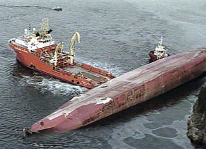A video grab shows rescue boat floating next to the capsized Norwegian-owned freighter Rocknes