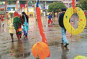 Shoppers look for shelter as rain catches them unawares in Sector 17