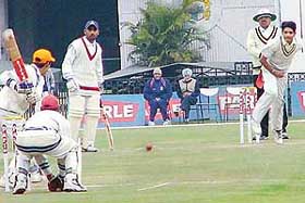 Sandeep Bhalla of DAV School, Sector 8, Chandigarh, bowls to Luxmi of Atma Ram Kumar Sabha at the PCA Parle Cricket 