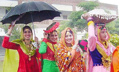 Participants of the Dhee Punjaban contest wait in the rain for their turn on the final day