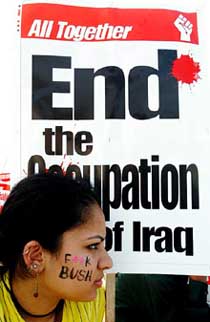 An anti-globalisation activist carries a poster at the World Social Forum