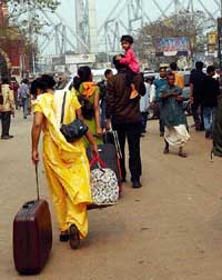 Passengers reach the Howrah railway station during bus-and-taxi strike in Kolkata