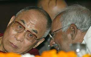 Tibetan spiritual leader, the Dalai Lama, listens to the convenor of Indian Parliamentary Movement for Tibet