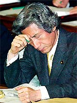 Japan's Prime Minister Junichiro Koizumi ponders during a question and answer session at the lower house of Parliament in Tokyo 
