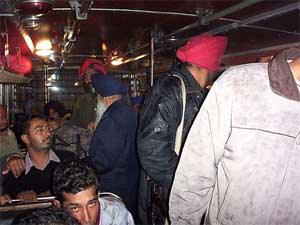 Punjab police personnel check a bus on the Sirhind-Patiala road following the Burail jail break 