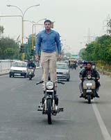Amar Sharma, a student, who drives a motor cycle while showing his driving skills on Ferozepore Road