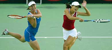 China's Yan Zi  and Zheng Jie go for a shot during their first round doubles match against Australia's Rennae Stubbs and Zimbabwe's Cara Black at the Australian Open